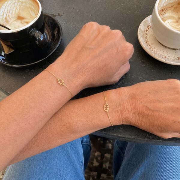 Best friends wearing matching knot bracelets